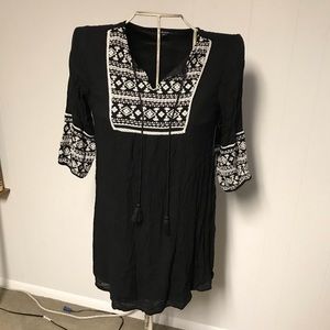 Black dress with white crocheted details.